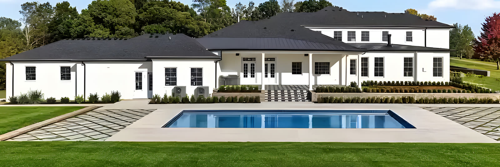 Back of the house with the pool and lawn